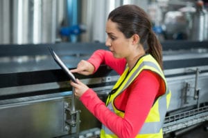 woman in manufacturing plant on tablet